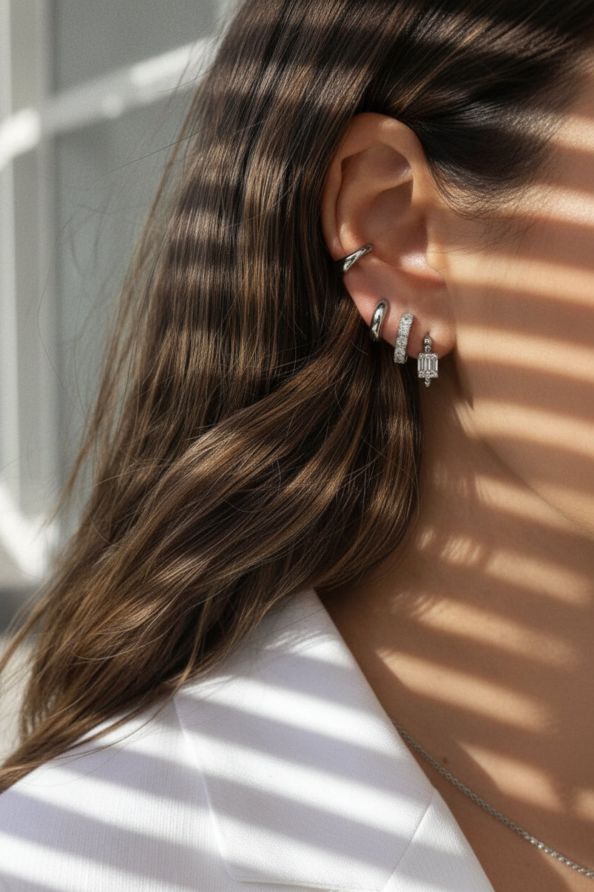 luxury silver huggie earrings stacked. showcasing carrie, bailey, camille and our sophiya cuff stack