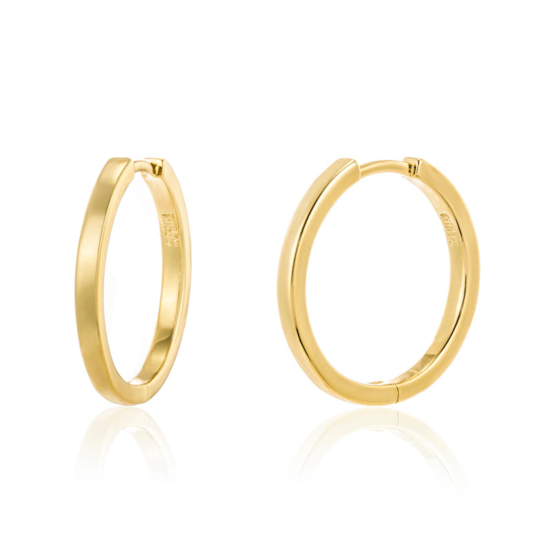 A close up product shot of Cassie gold hoop earrings with the brand name 'SOPHIYA' debossed onto the interior rim.