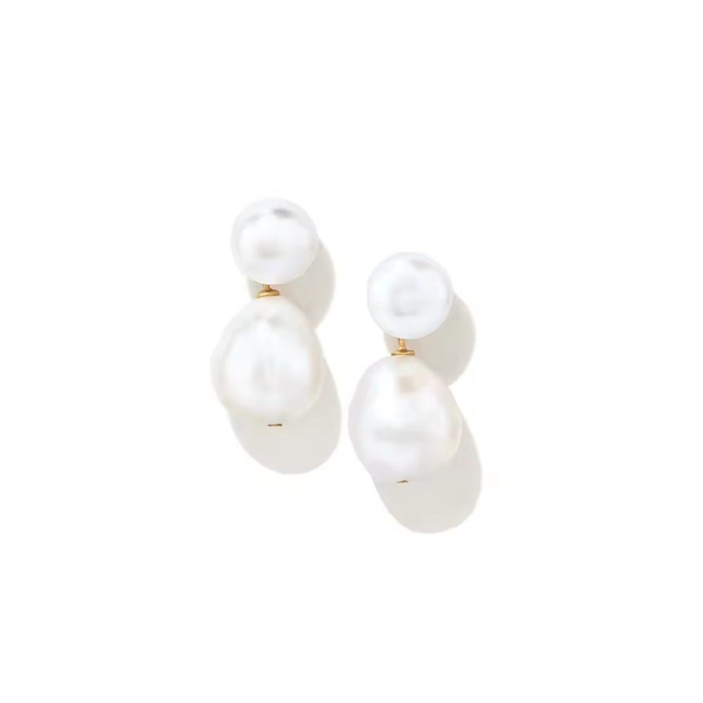 Studio close up of semi round high luster reflective pearls, dangle push back earrings.