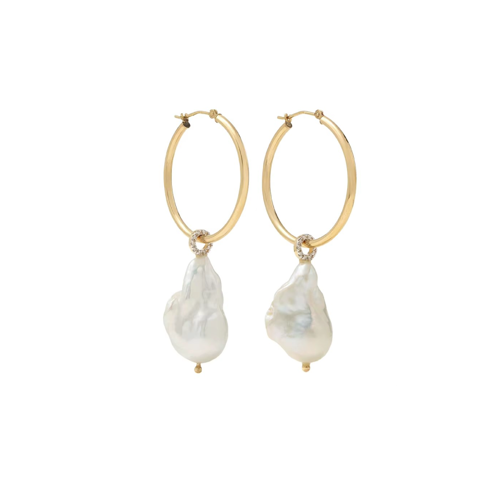 a studio close up of studded cz diamond baroque pearl earrings with 18k gold plated hoops with a white backdrop