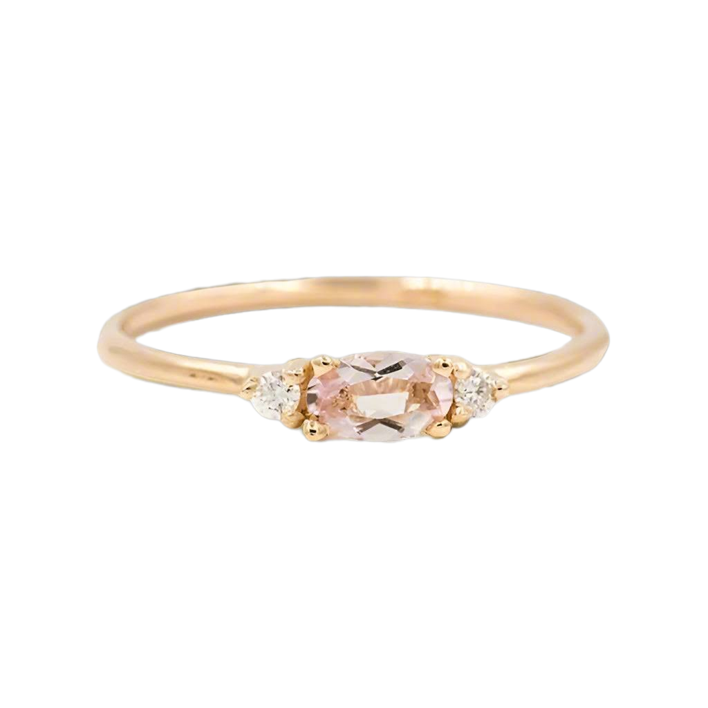 details of three stone white gold ring with rose gemstone