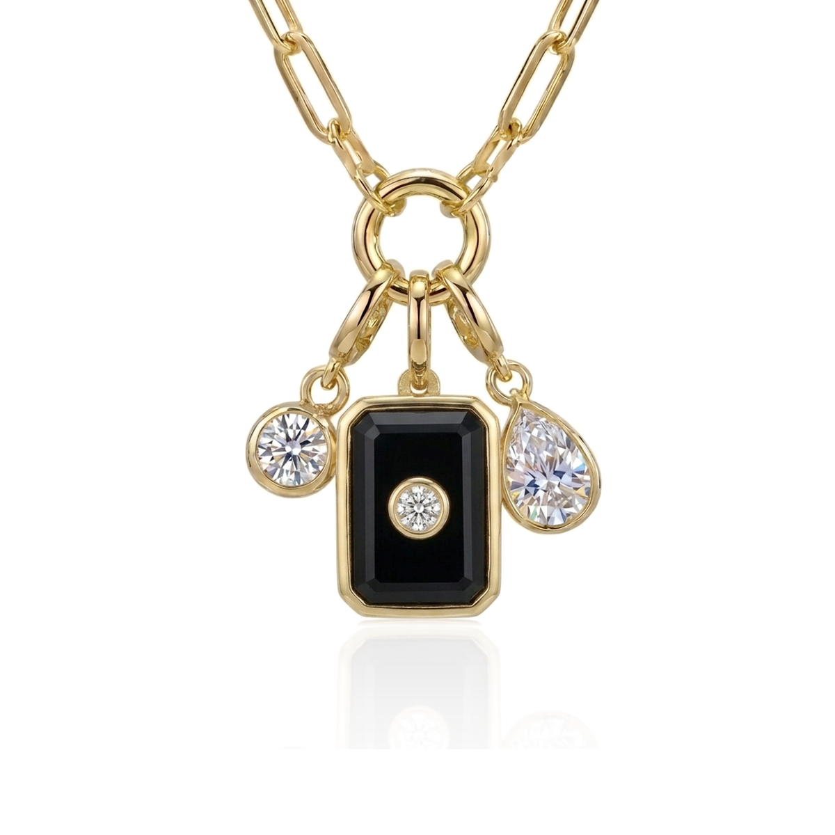 A gold chain necklace with a rectangular black onyx pendant featuring a small clear gemstone in the center, flanked by two smaller dangling clear gemstones on a white background.