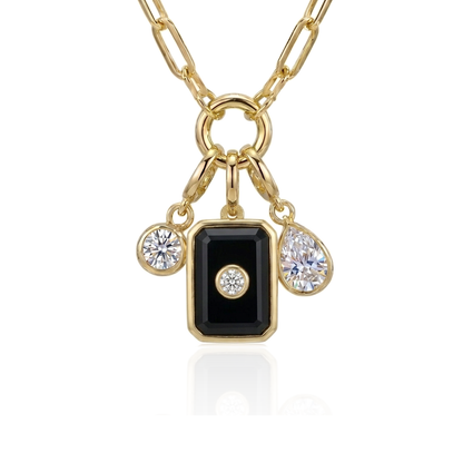 A gold chain necklace with a rectangular black onyx pendant featuring a small clear gemstone in the center, flanked by two smaller dangling clear gemstones on a white background.