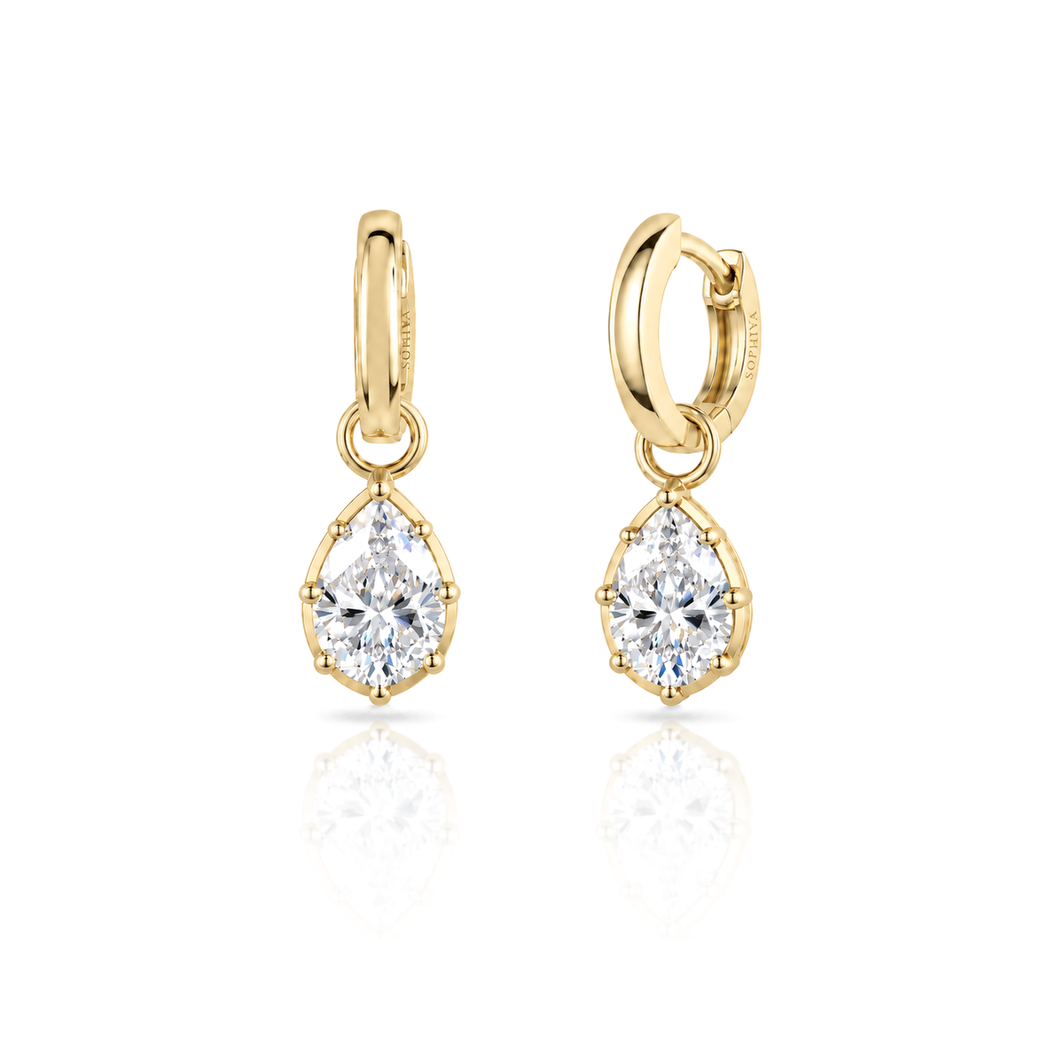 A pair of gold huggie hoop earrings with pear-cut diamond drops, displayed on a clean white background with a soft reflection below.
