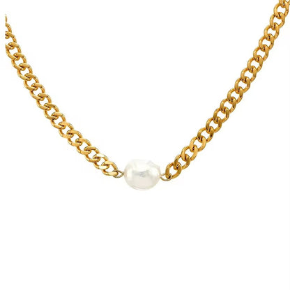Detailed close up 18k gold plated chunky necklace with baroque pearl - a gold flat bevelled curb chain