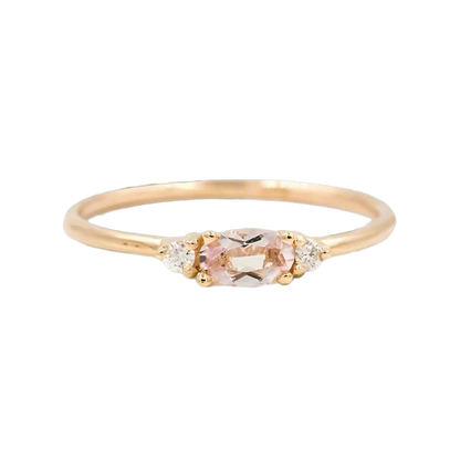 details of three stone  white gold ring with rose gemstone