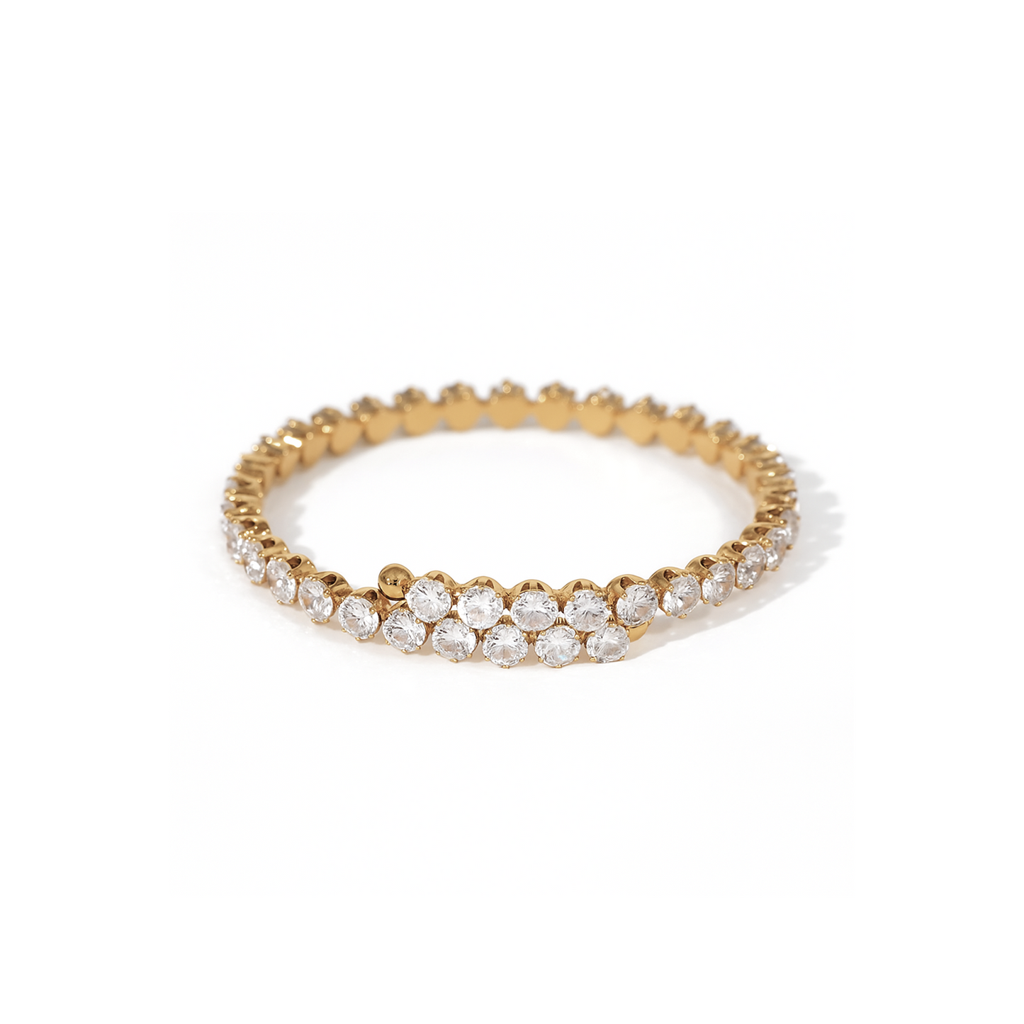 Gold bracelet with clear stones on a white background