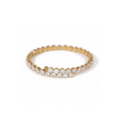 Gold bracelet with clear stones on a white background